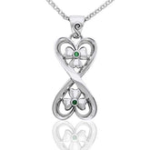 Silver connected hearts pendant with shamrock and green gemstones on a white background